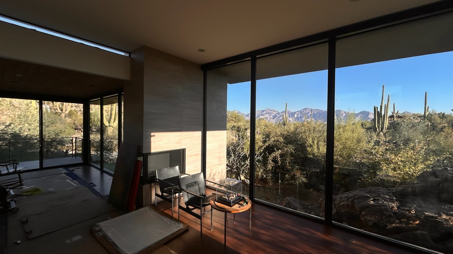 Spotless floor-to-ceiling windows framing saguaros and the Catalina mountains
