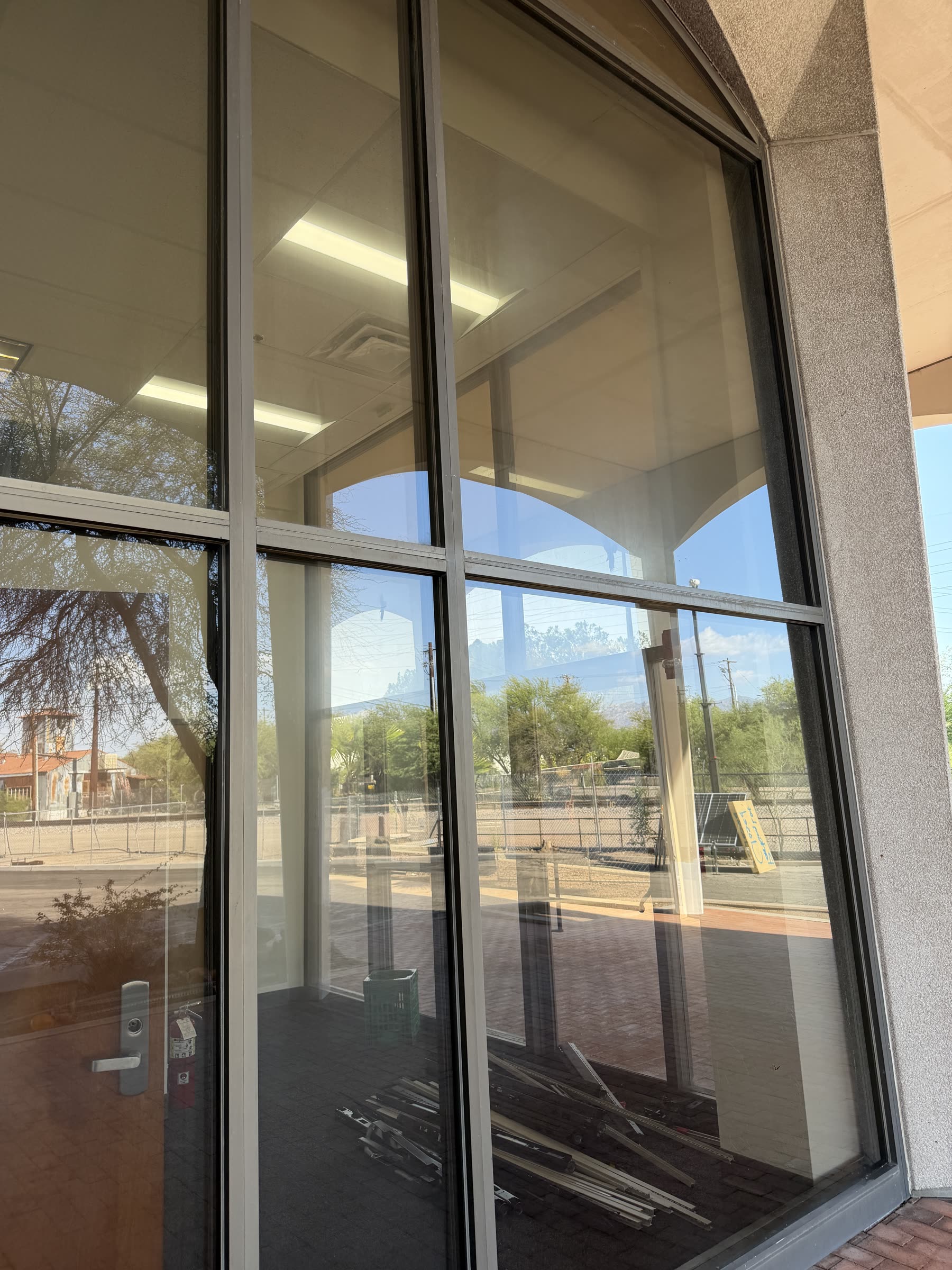 Spotless commercial storefront glass with clean frames and arched entry